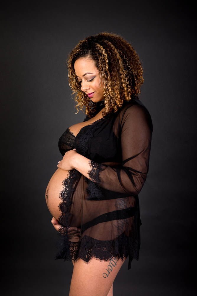 Esteem Boudoir Atlanta Boudoir Photographer - low key boudoir maternity photo beautiful African American model holding baby bump Atlanta Maternity Photographer